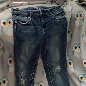 Dark wash blue jeans ripped on the knees